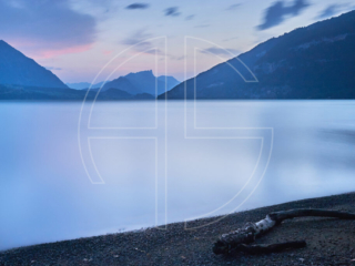 Silky smooth water of the Thunersee at dusk.
