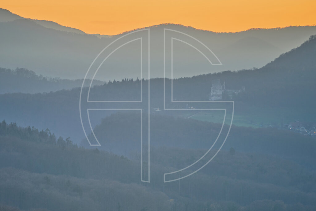 Absence Of Judgement Forested hills in haze at dusk.