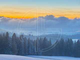 Below The Horizon Low clouds cover most of the winter landscape at dusk.