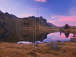 Pink sunset at a mountain lake.