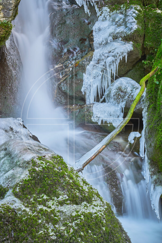 Small waterfall with icicles in winter.