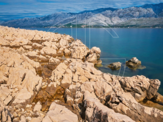 Soft light shinning on rocks. The background has mountains.