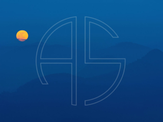 The full moon rises in a hilly, deep blue landscape.