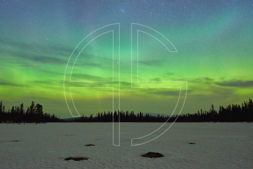 Northern Lights at a snow-covered lake.