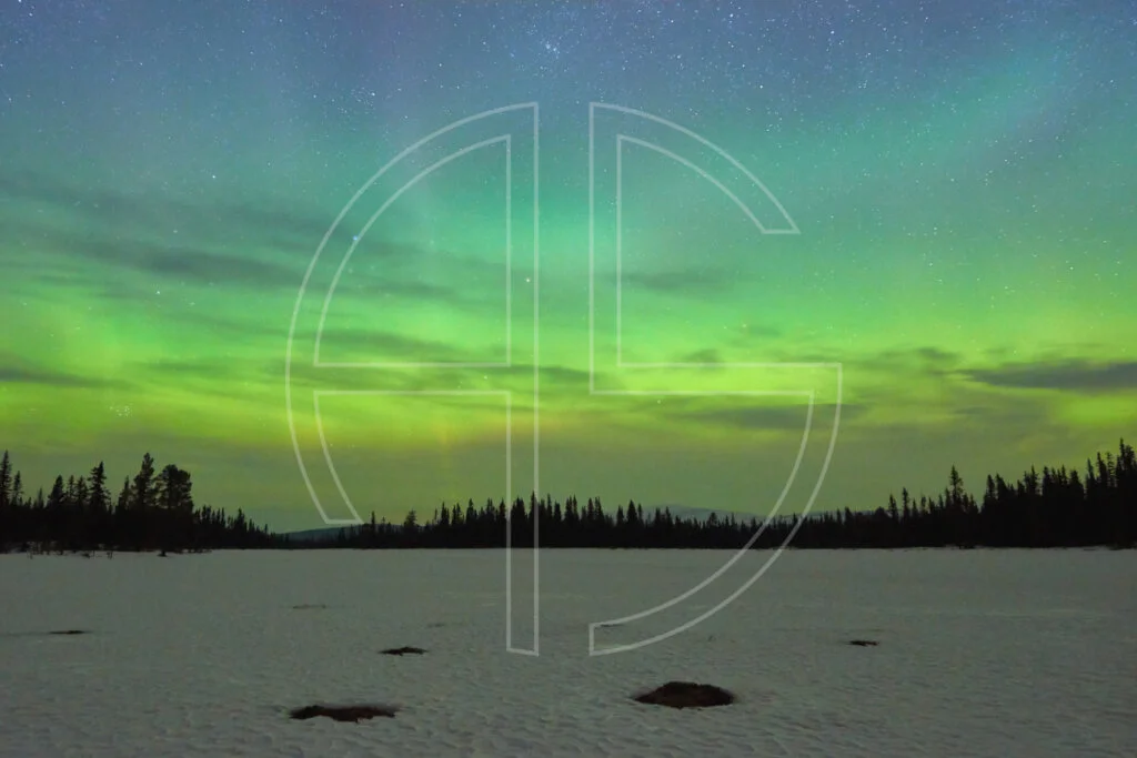 Haunted By Visions Northern Lights at a snow-covered lake.