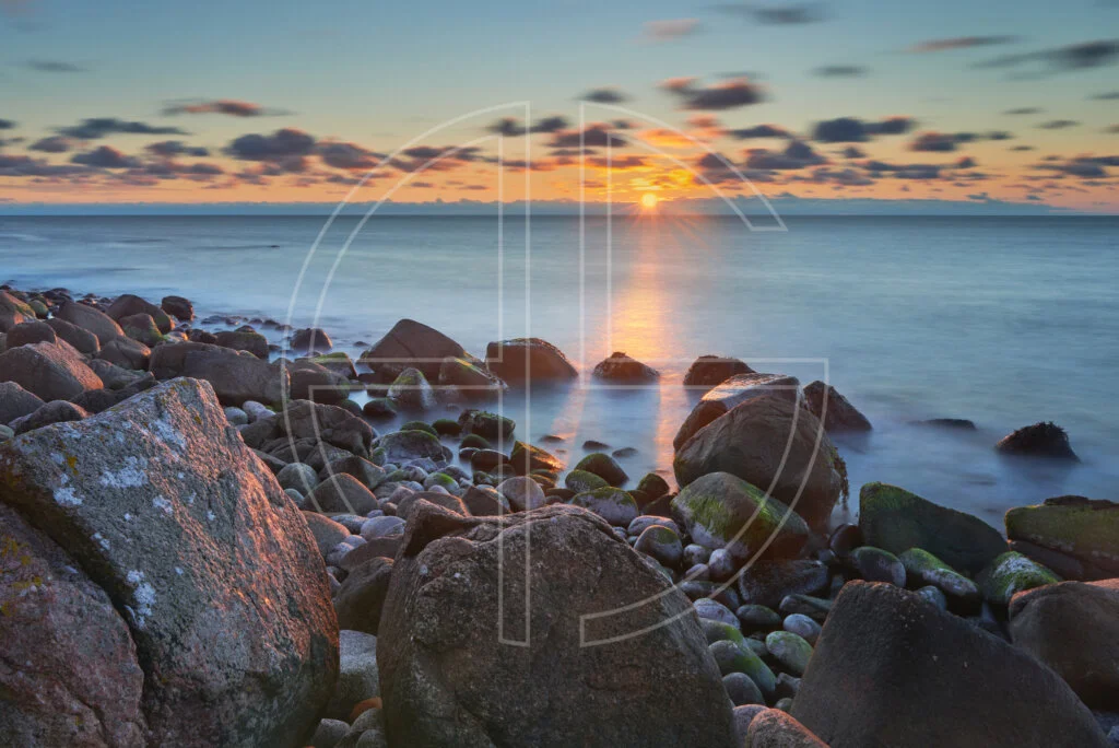 Sunset at a rocky beach.