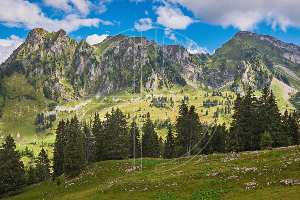 Soft sunlight illuminates a mountain range.