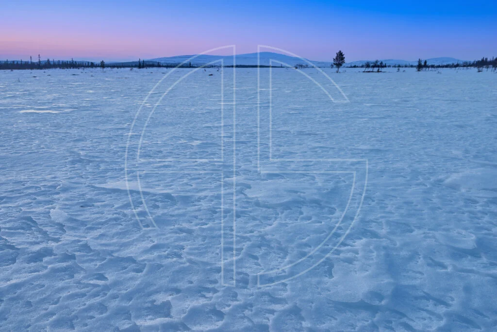 Starless Aeon A snow-covered frozen field at dusk.