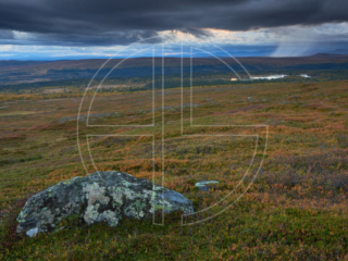Fjell landscape with dark sky. A solitary rain cloud drifts to the right.