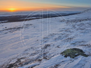 Sunset on a snow-covered hill.