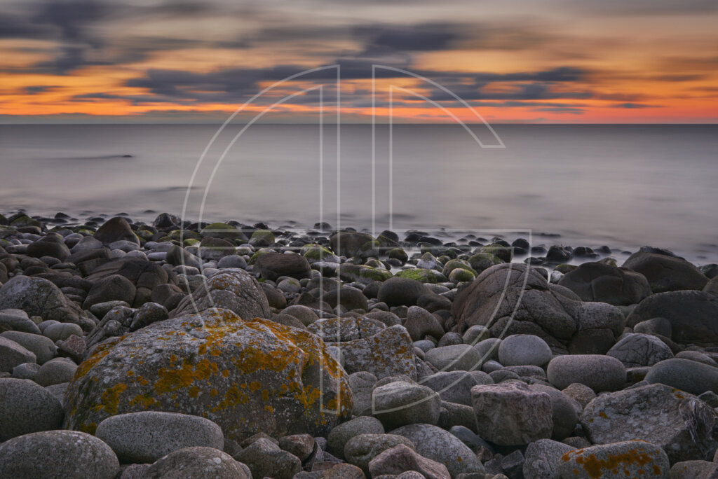 Dusk at a rocky beach.