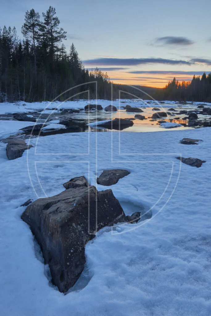 To Carve Another Wound A snow-covered river at sunset.