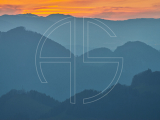 Layers of wooded hills at dusk.