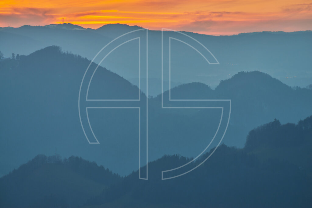 Layers of wooded hills at dusk.