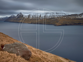 A fjord with mountains in the background.