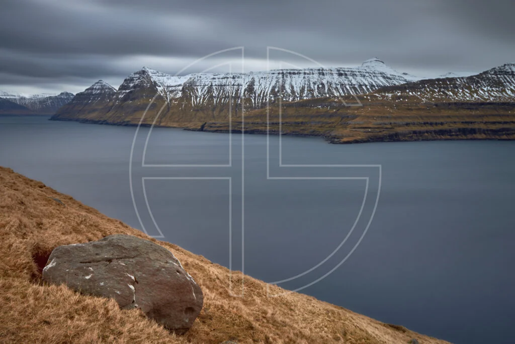 A fjord with mountains in the background.
