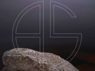 Xenomorph Big stones in the foreground and a lake in the background.